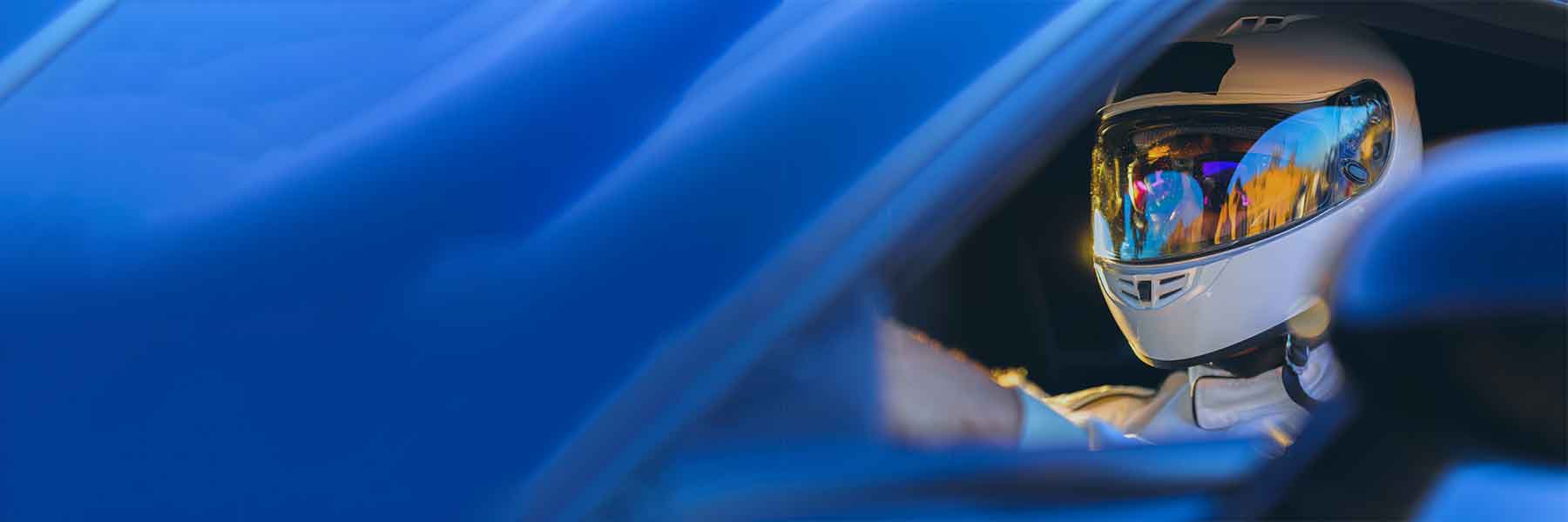 Racing Car Driver behind the wheel of a blue car to promote Goober & Doofus Driver Series products.