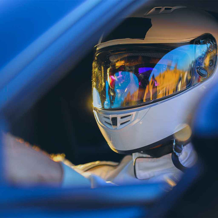 Close-up of race car driver wearing a helmet to promote Goober & Doofus's F1 Drivers Series t-shirts